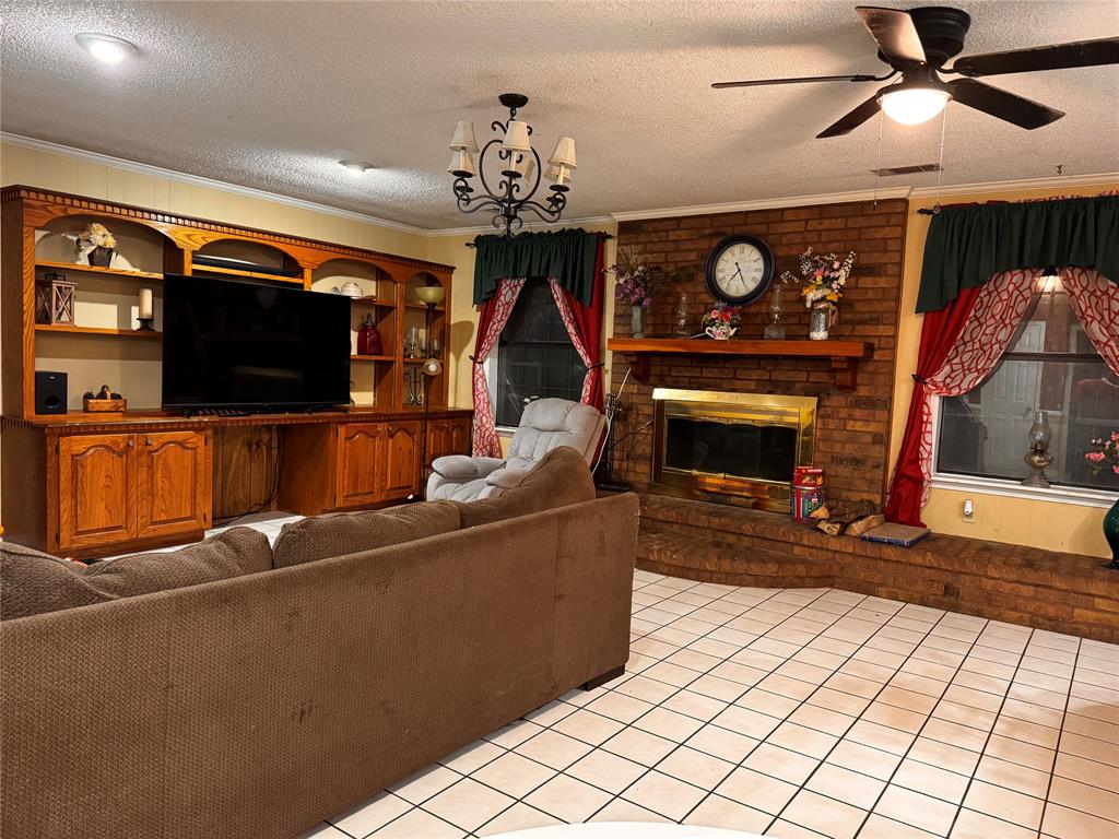 620 Fort Avenue Minden, LA 71055 - Photo 5 of 7 a living room with furniture a flat screen tv and a fireplace