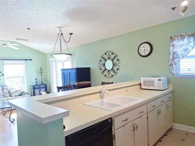 a bathroom with a granite countertop sink toilet mirror and bathtub