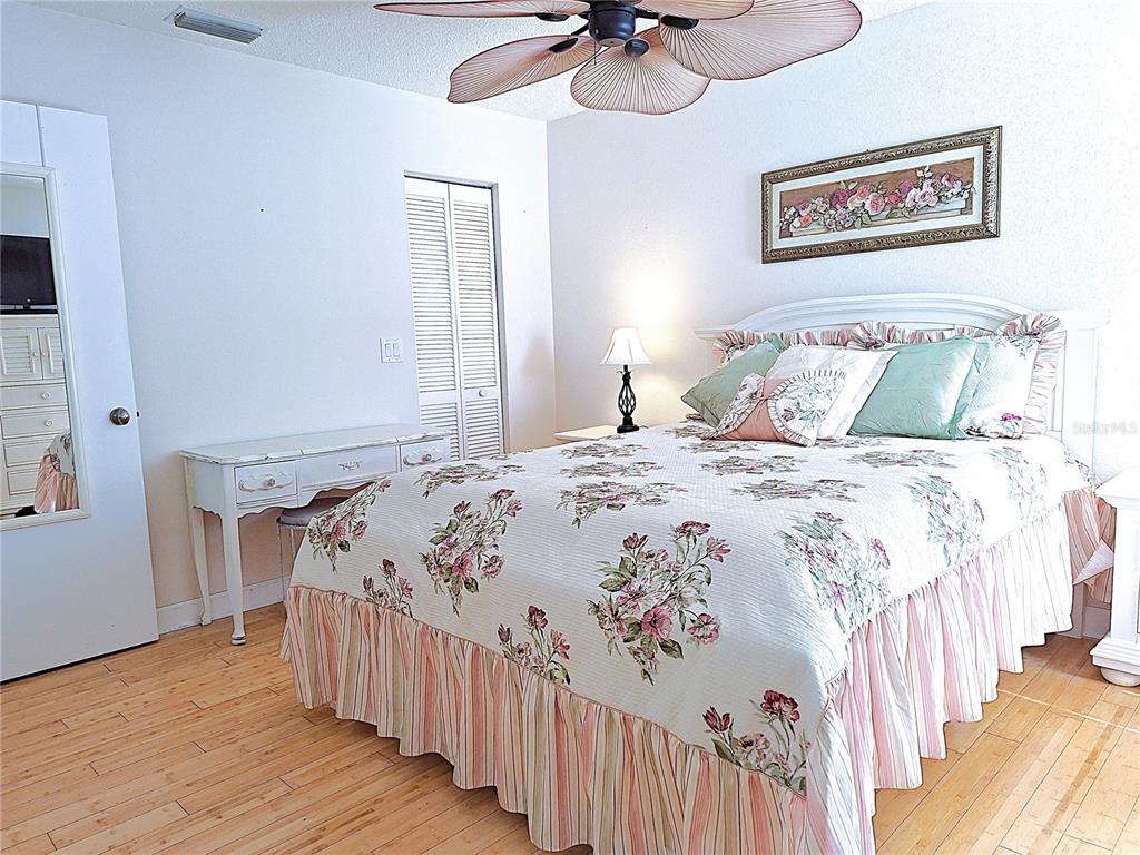 5727 Biscayne Court, Unit 302 New Port Richey, FL 34652 - Photo 15 of 45 a bedroom with bed and wooden floor