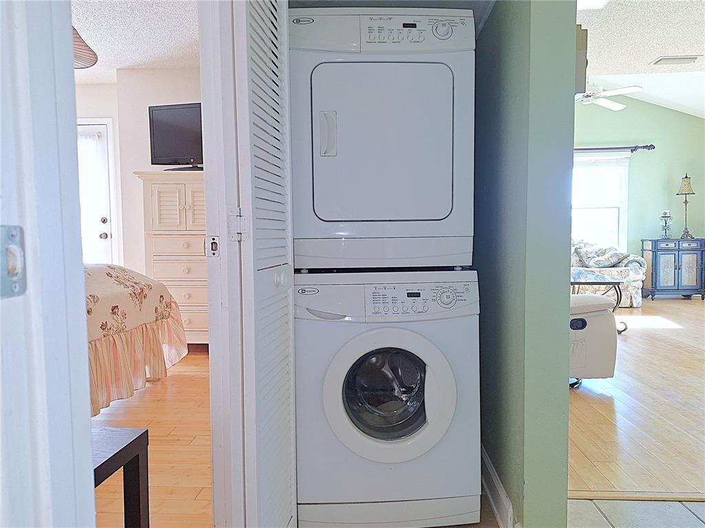 5727 Biscayne Court, Unit 302 New Port Richey, FL 34652 - Photo 19 of 45 a utility room with dryer and washer