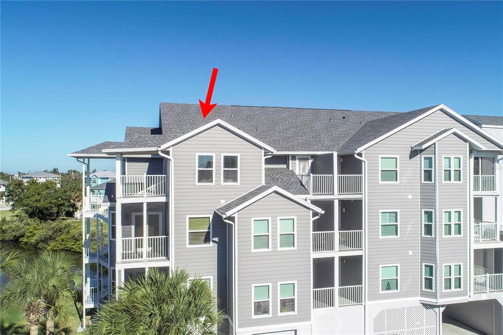 5727 Biscayne Court, Unit 302 New Port Richey, FL 34652 - Photo 2 of 45 a front view of a house with a yard