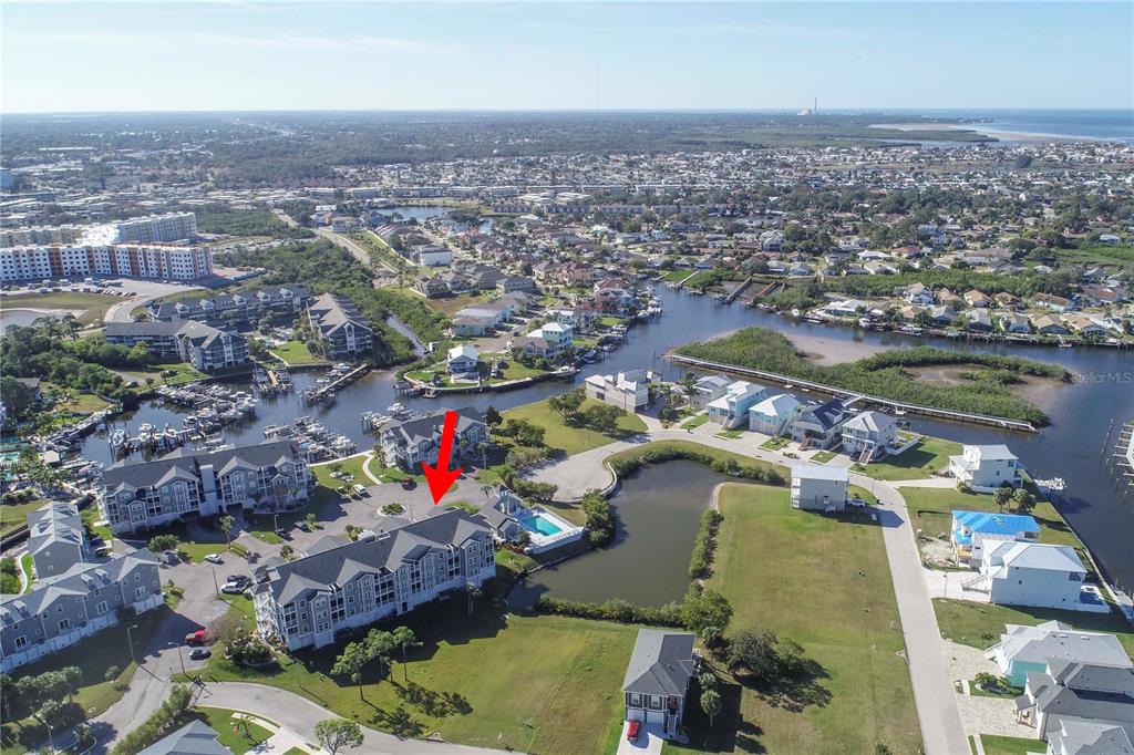 5727 Biscayne Court, Unit 302 New Port Richey, FL 34652 - Photo 24 of 45 an aerial view of lake and residential houses with outdoor space