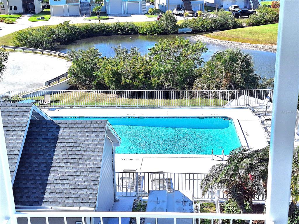 5727 Biscayne Court, Unit 302 New Port Richey, FL 34652 - Photo 26 of 45 a view of a swimming pool and a yard