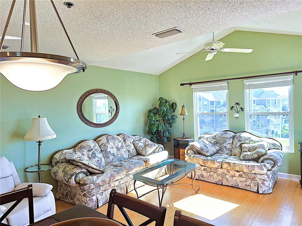 5727 Biscayne Court, Unit 302 New Port Richey, FL 34652 - Photo 6 of 45 a living room with furniture and a large window