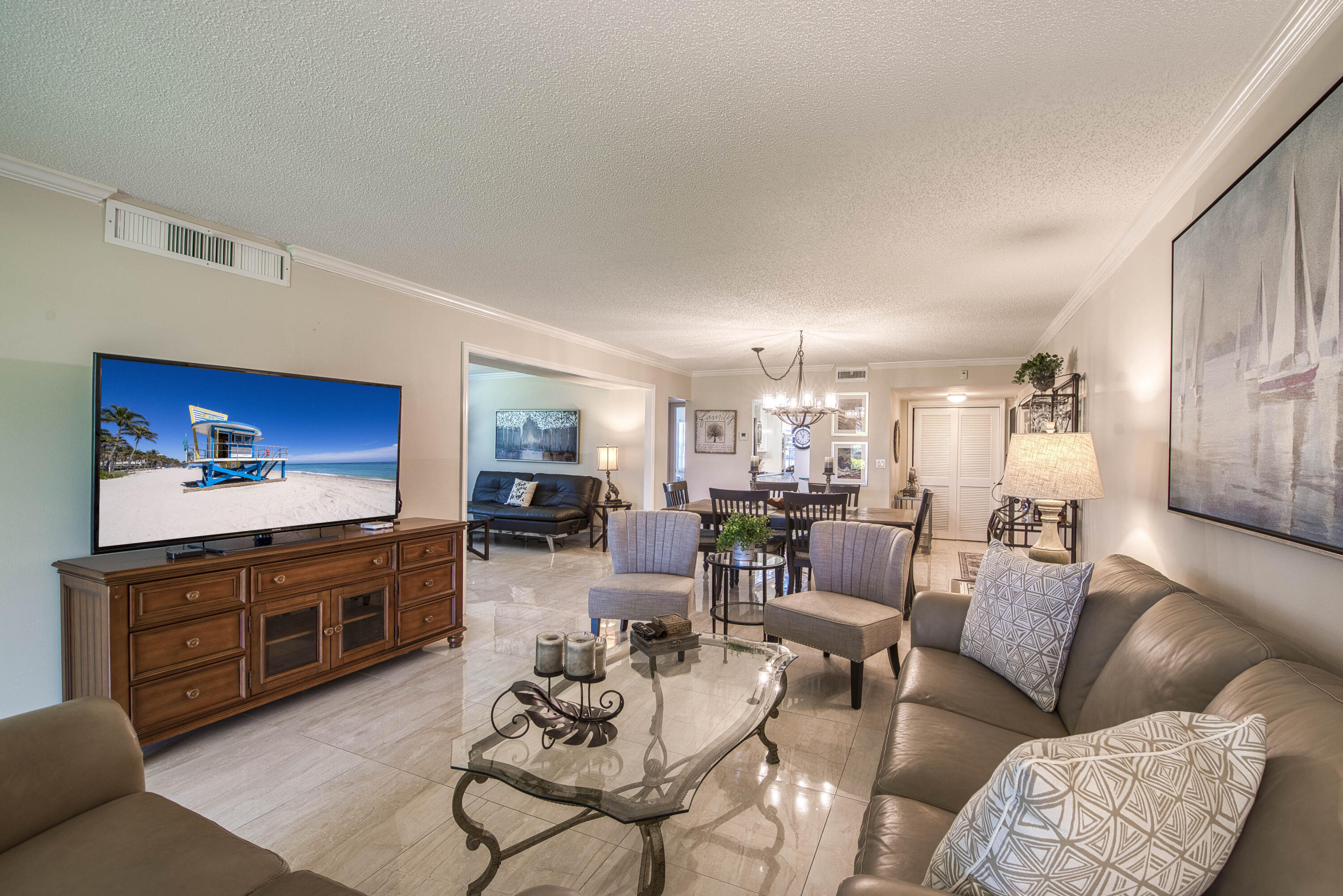 1205 Sandy Lane, Unit 149 Singer Island, FL 33404 - Photo 12 of 28 a living room with furniture kitchen view and a wooden floor