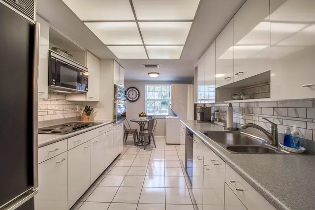 a kitchen with stainless steel appliances granite countertop a sink and cabinets