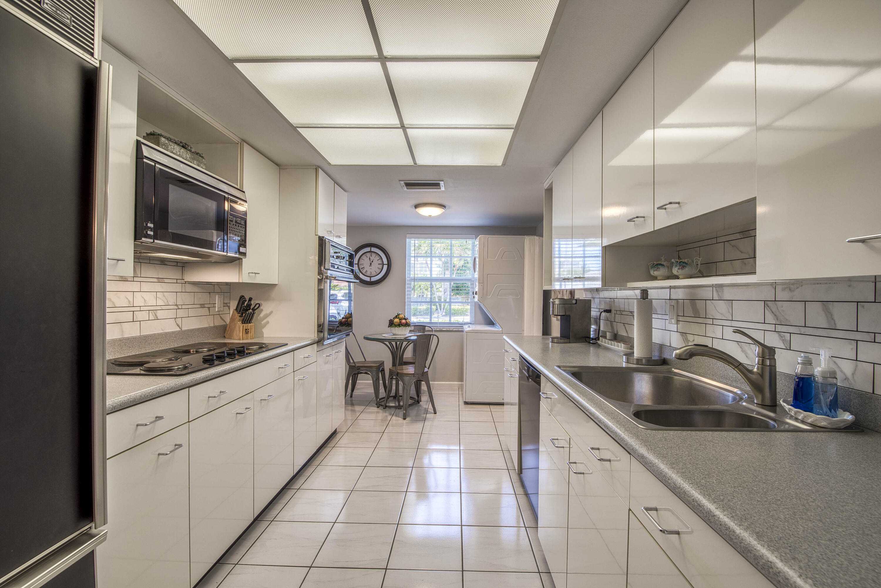 1205 Sandy Lane, Unit 149 Singer Island, FL 33404 - Photo 14 of 28 a kitchen with stainless steel appliances granite countertop a sink and cabinets