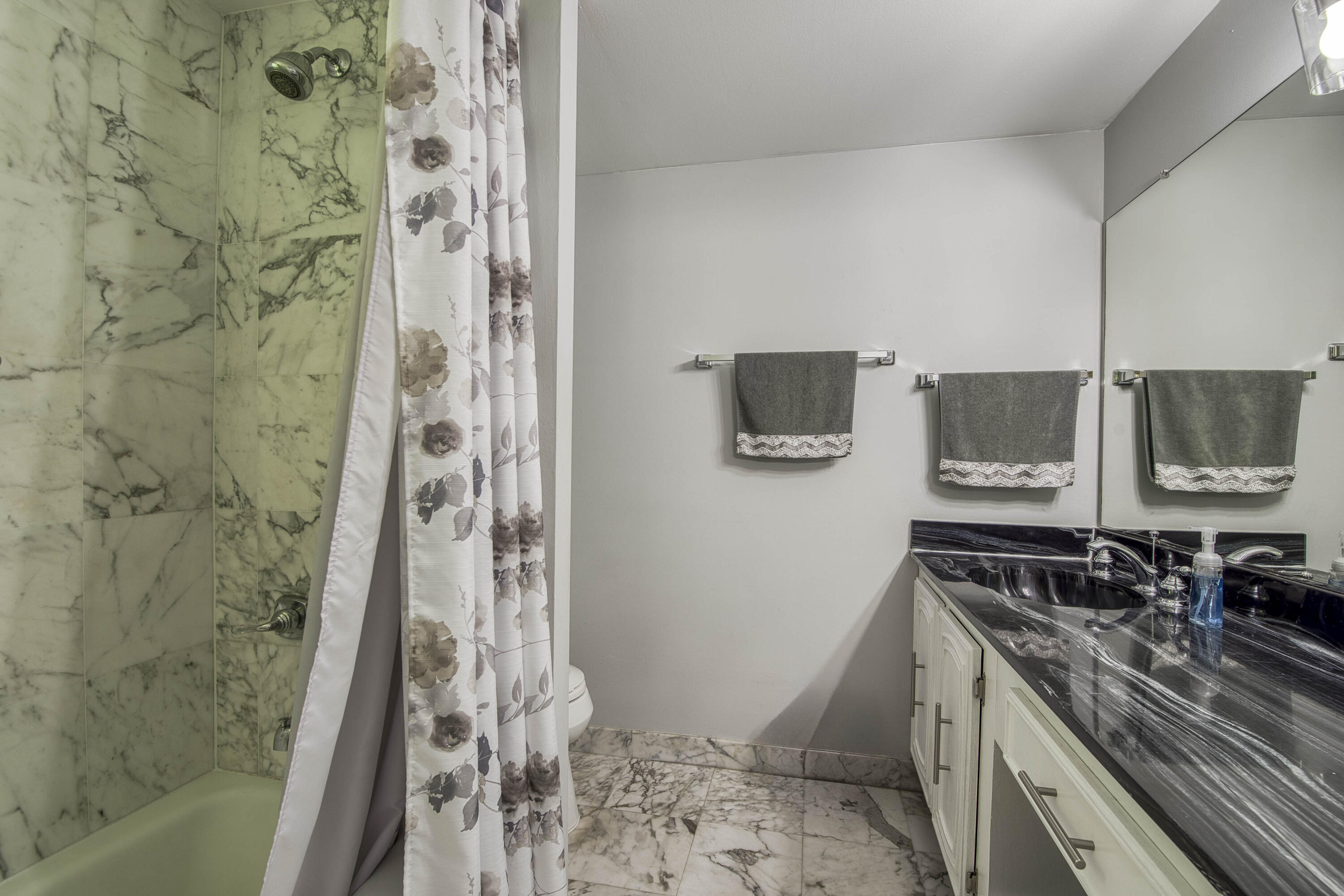 1205 Sandy Lane, Unit 149 Singer Island, FL 33404 - Photo 22 of 28 a kitchen with a sink a stove a microwave and a shower