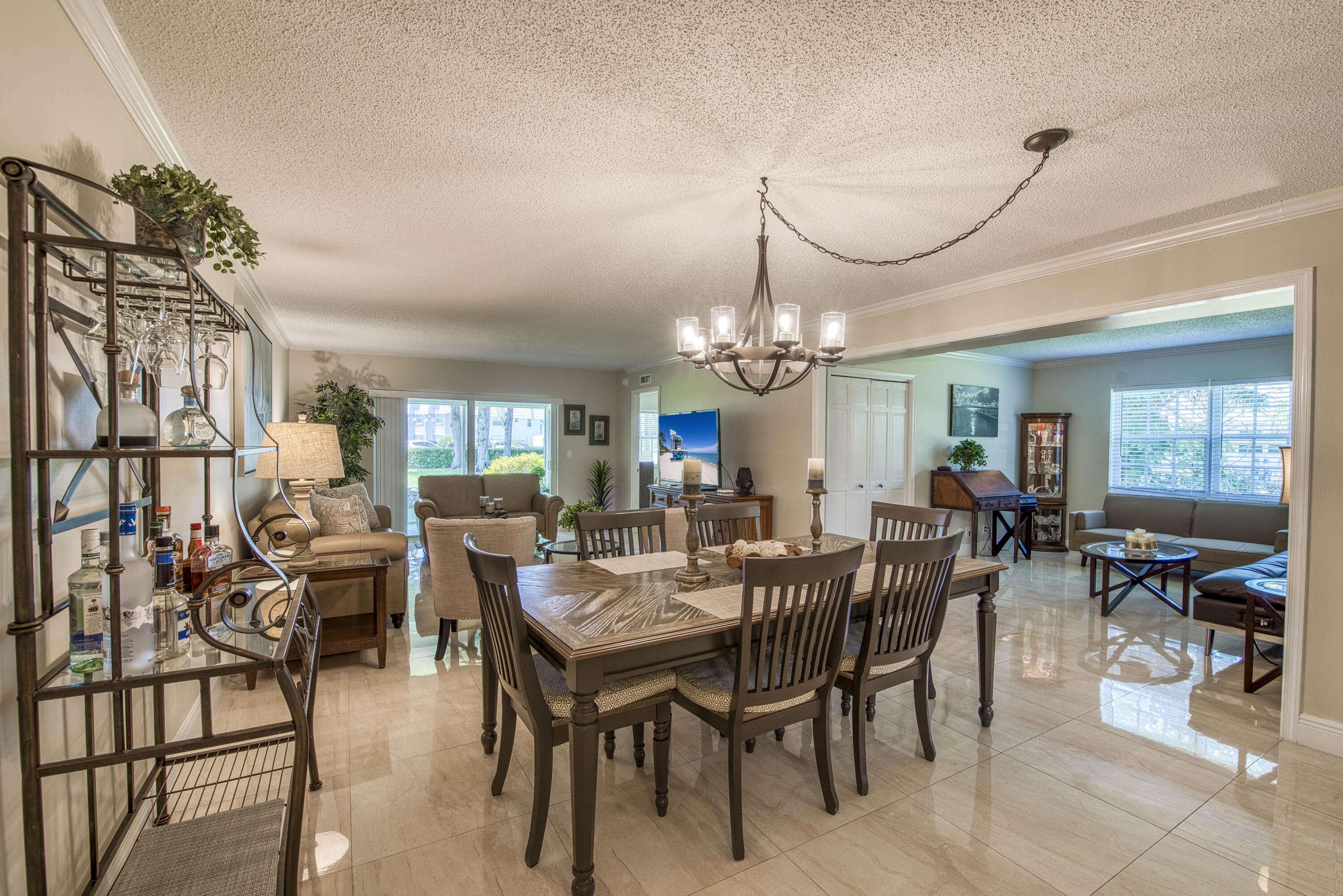 1205 Sandy Lane, Unit 149 Singer Island, FL 33404 - Photo 4 of 28 a view of a dining room with furniture window and wooden floor