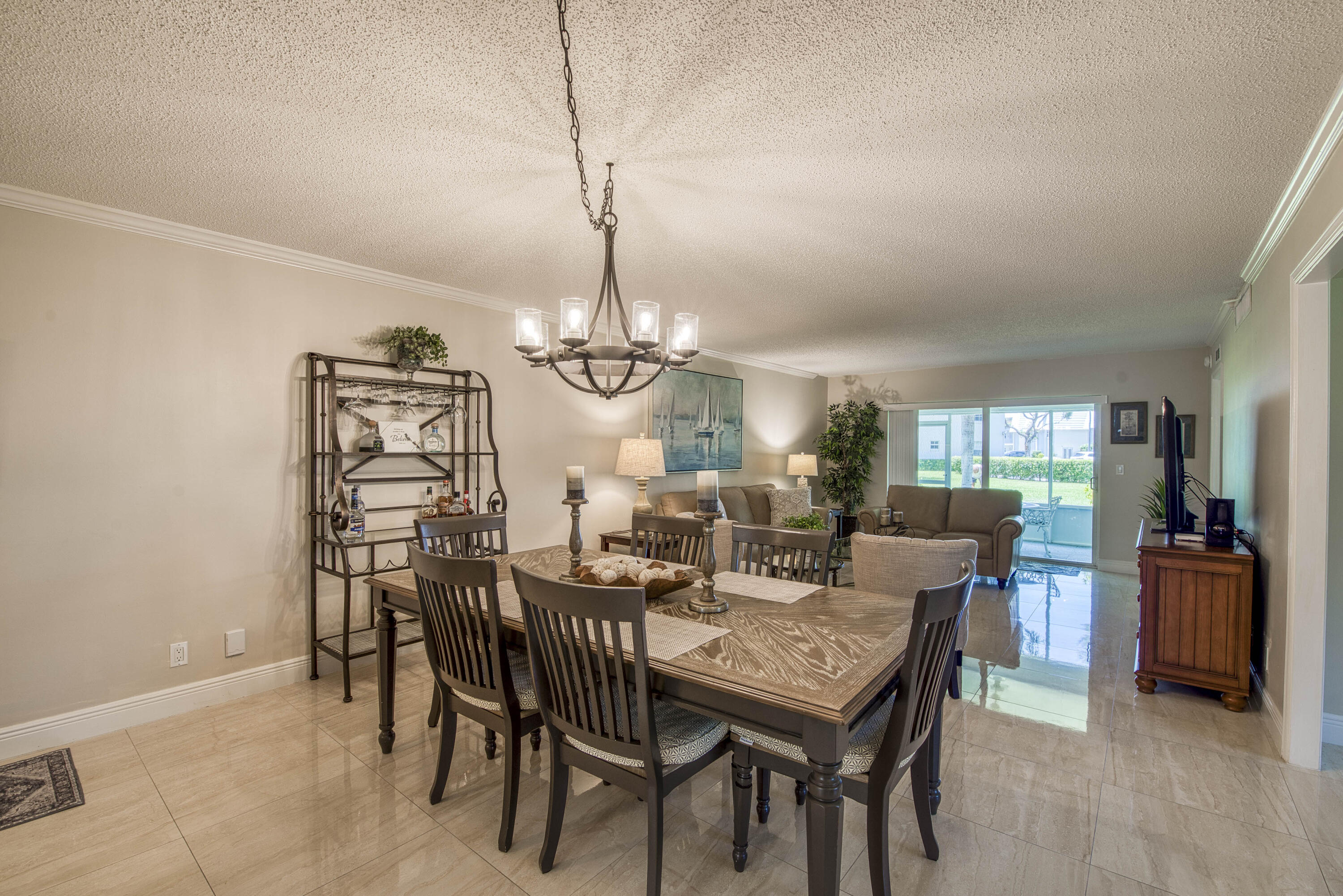 1205 Sandy Lane, Unit 149 Singer Island, FL 33404 - Photo 6 of 28 a view of a dining room with furniture window and wooden floor