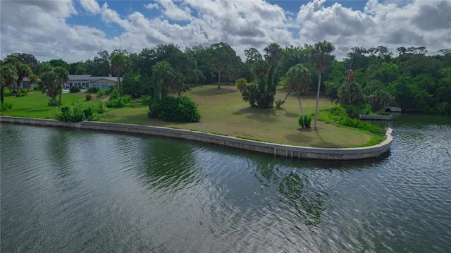 a view of a lake with a house in the background