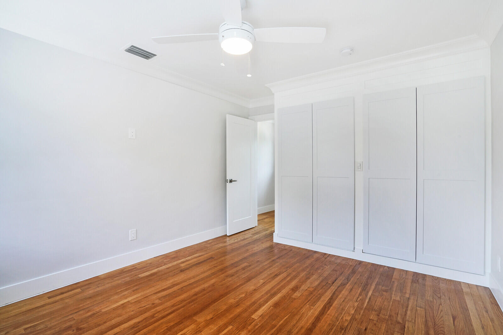 29 E Road Delray Beach, FL 33483 - Photo 19 of 34 a view of an empty room with wooden floor