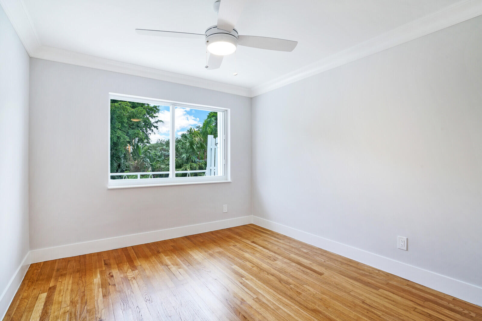 29 E Road Delray Beach, FL 33483 - Photo 20 of 34 wooden floor in an empty room with a window