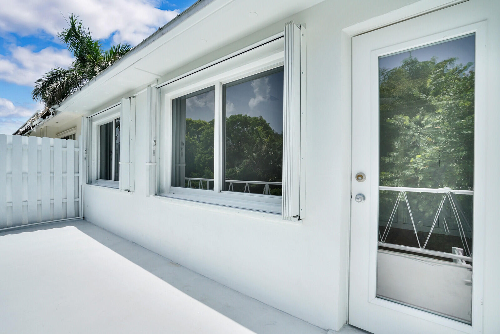 29 E Road Delray Beach, FL 33483 - Photo 25 of 34 a view of a house with a large window and potted plants
