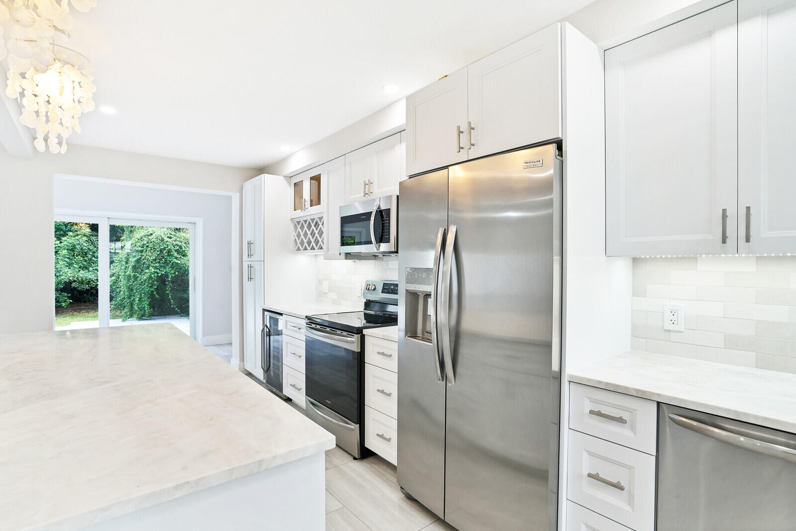 29 E Road Delray Beach, FL 33483 - Photo 9 of 34 a kitchen with stainless steel appliances a refrigerator sink and microwave