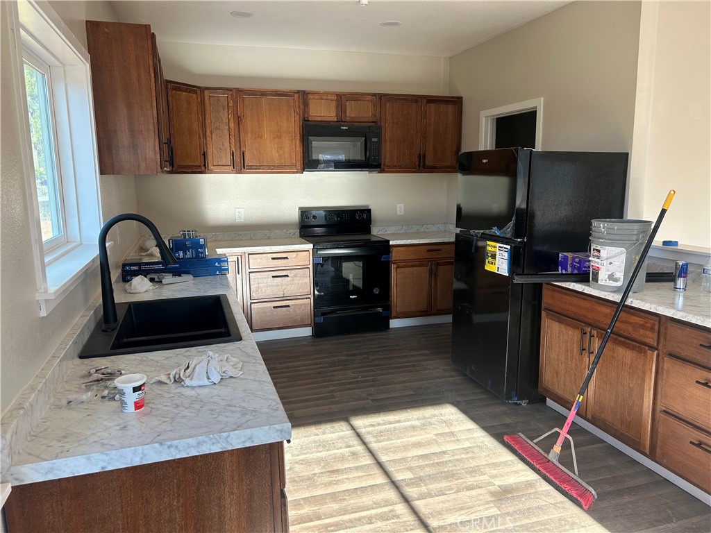 14014 Creston Road Magalia, CA 95954 - Photo 13 of 30 a kitchen with granite countertop a stove a sink and a microwave