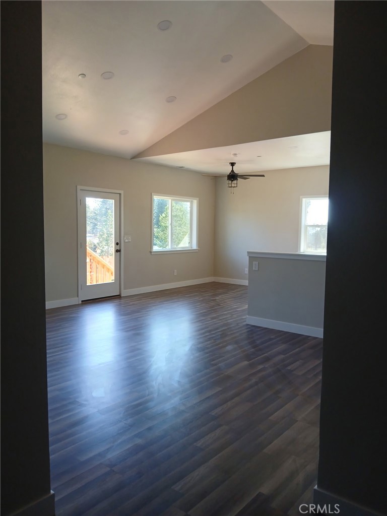 14014 Creston Road Magalia, CA 95954 - Photo 14 of 30 an empty room with wooden floor and windows
