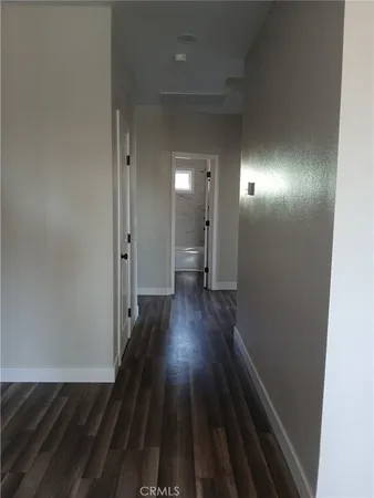 a view of hallway with wooden floor