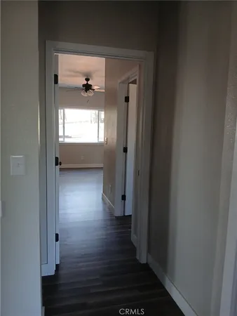 a view of hallway with wooden floor