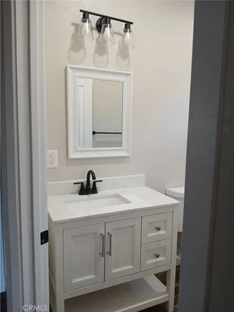 a bathroom with a sink a vanity and a mirror