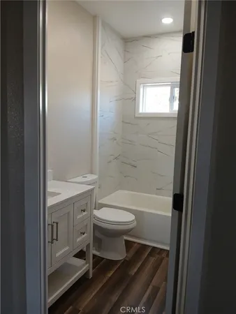 a bathroom with a toilet a sink and bathtub