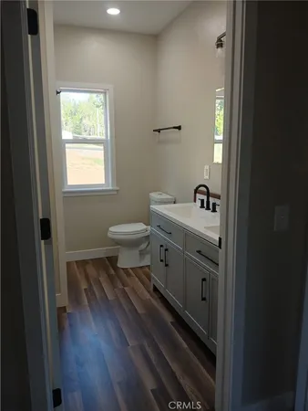 a bathroom with a sink a toilet and a window