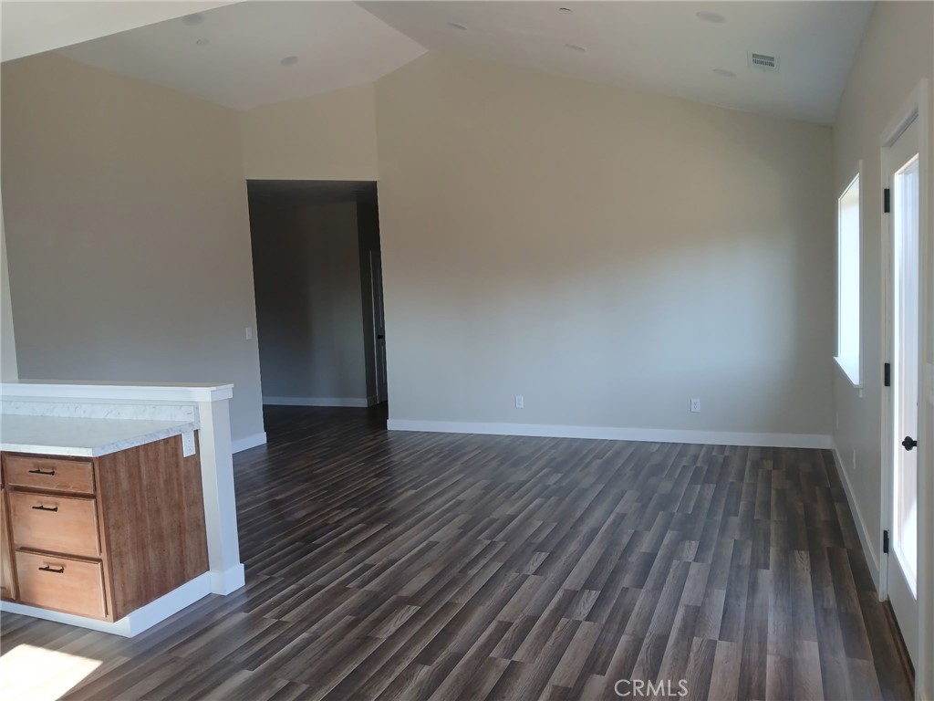 14014 Creston Road Magalia, CA 95954 - Photo 27 of 30 a view of an empty room with wooden floor and a window