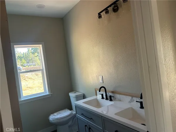 a bathroom with a sink toilet and a mirror