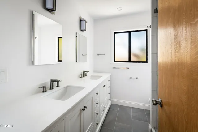 a bathroom with a double vanity sink a mirror and