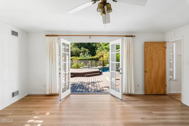 wooden floor in an empty room with a window