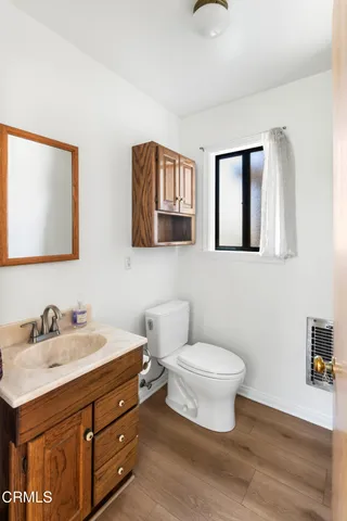 a bathroom with a toilet sink and mirror