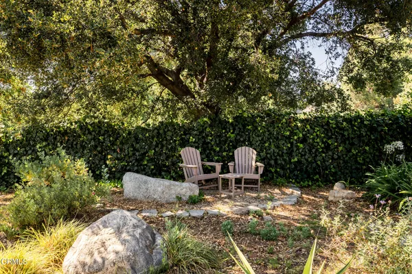 a view of a chairs and table in the patio