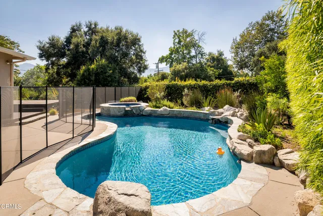 a view of a swimming pool with a patio and garden