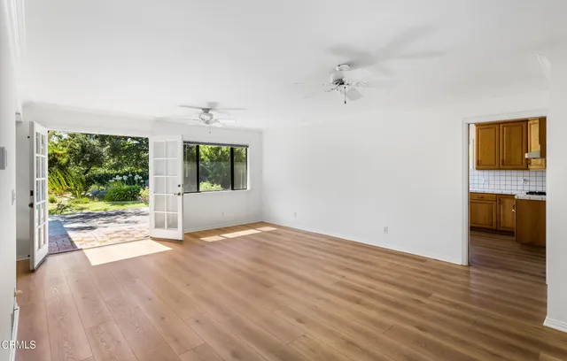 wooden floor in an empty room with a window