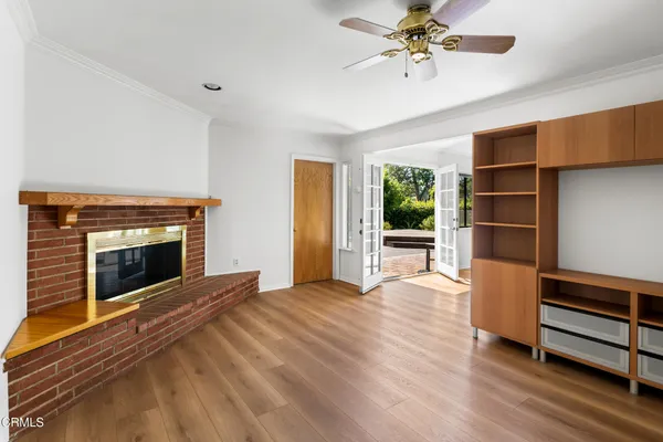 a view of an empty room with a fireplace and a window