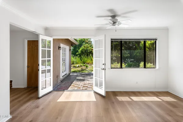 a view of a room with wooden floor and a rug