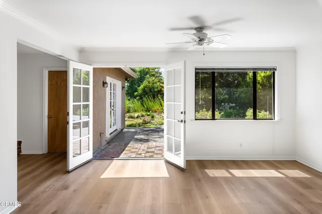 a view of a room with wooden floor and a rug