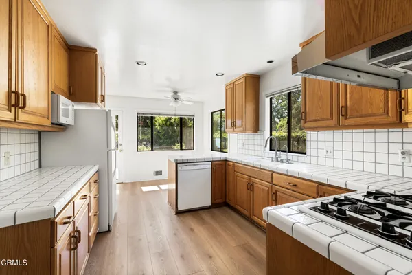 a kitchen with a stove a sink and a microwave