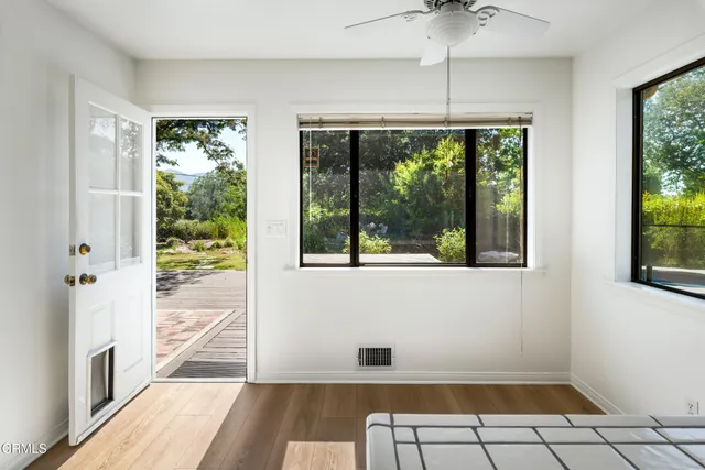 a view of an entryway with wooden floor and windows