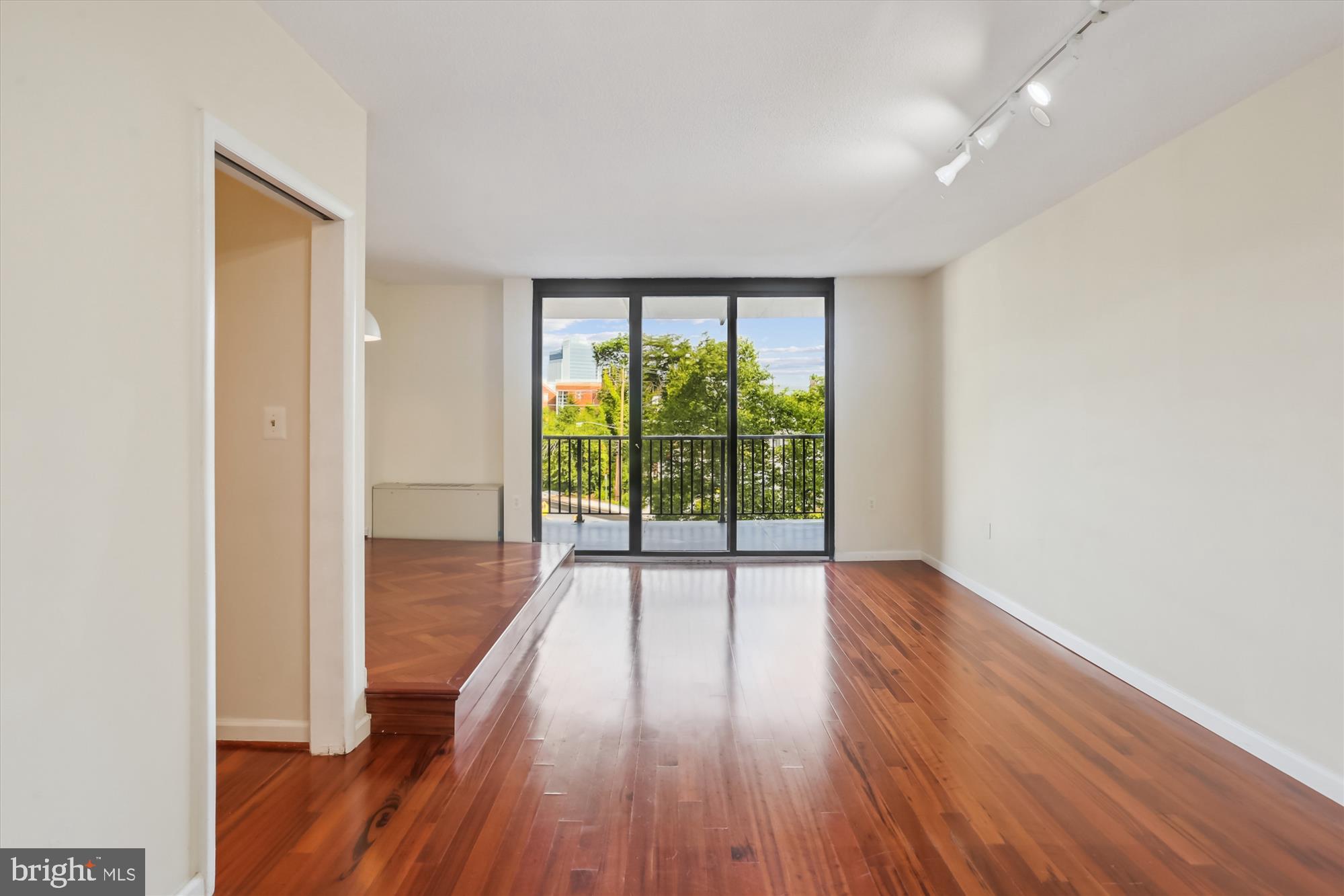 4242 East-West Highway, Unit 414 Chevy Chase, MD 20815 - Photo 12 of 66 wooden floor in an empty room with a window