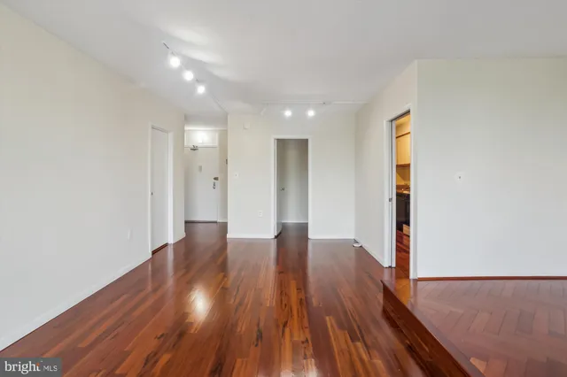 a kitchen that has a stove and a wooden floor