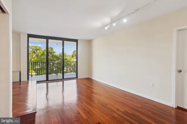 a kitchen with wooden floor and a stove top oven