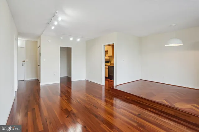 an empty room with wooden floor and closet