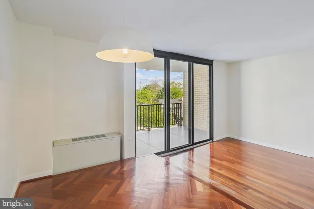 a view of a room with wooden floor