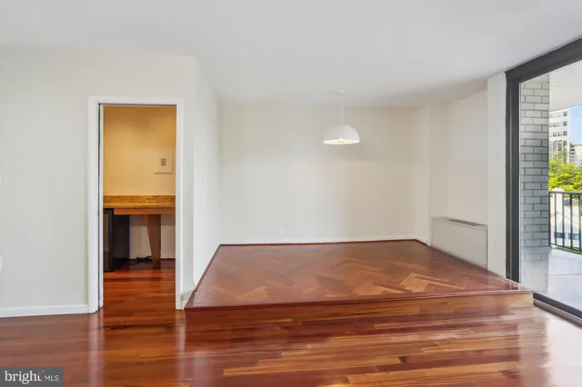 a view of an empty room with wooden floor