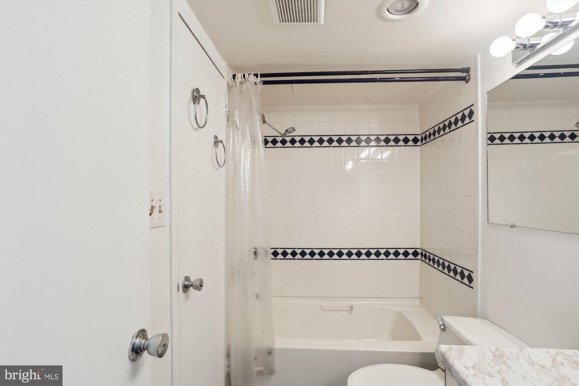 4242 East-West Highway, Unit 414 Chevy Chase, MD 20815 - Photo 27 of 66 a bathroom with a shower and a shower