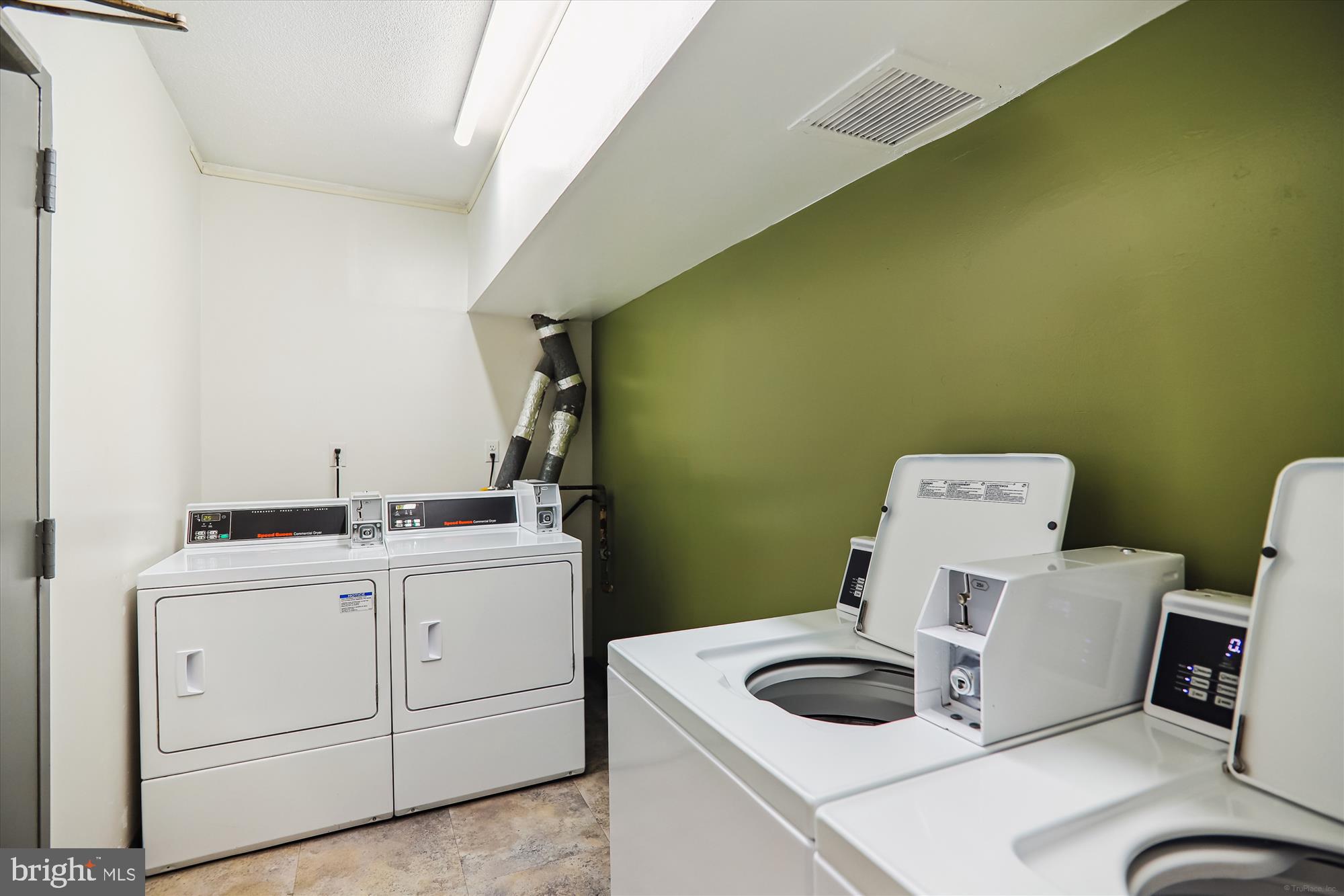 4242 East-West Highway, Unit 414 Chevy Chase, MD 20815 - Photo 31 of 66 a bathroom with a sink toilet and vanity