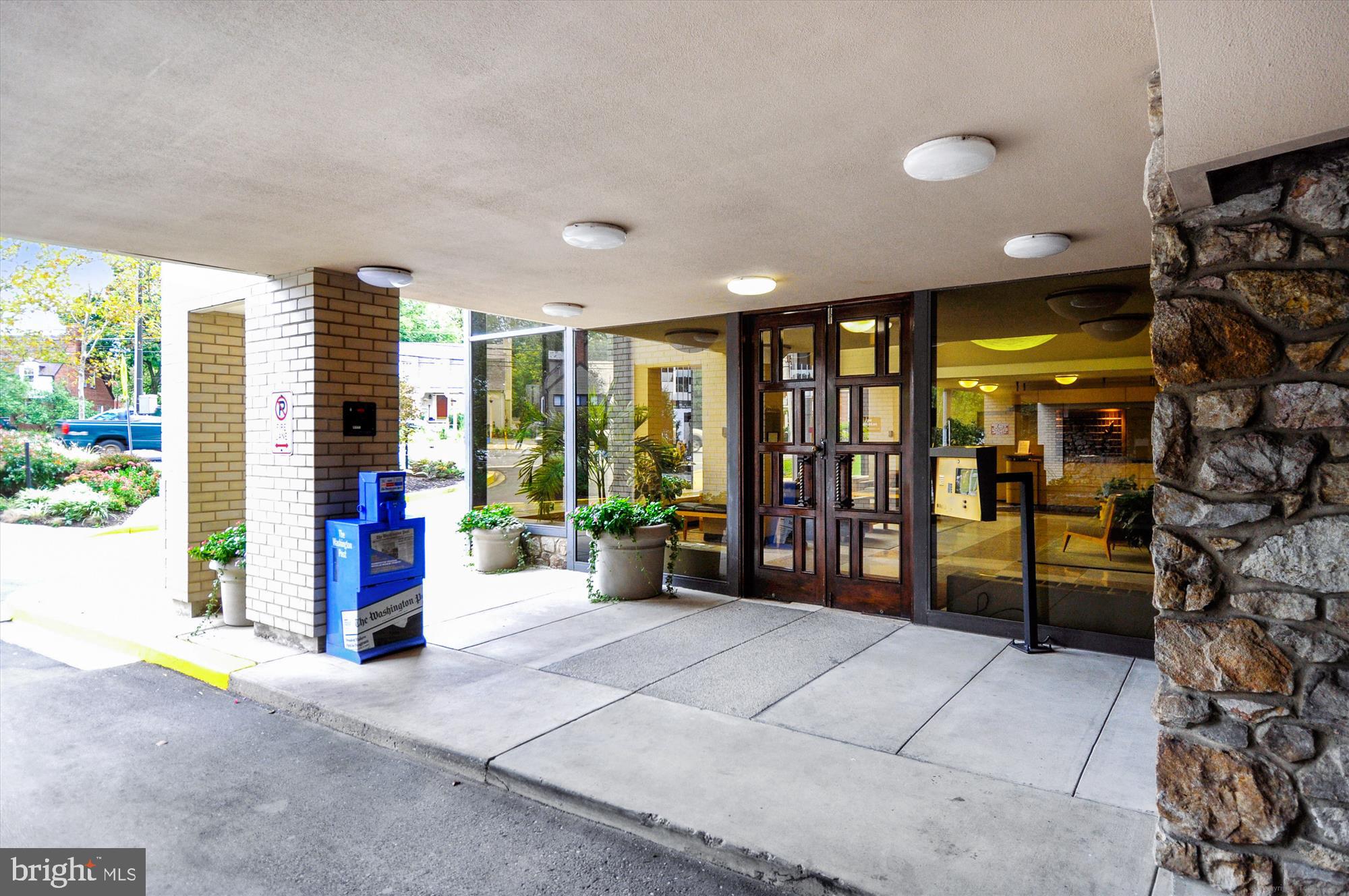 4242 East-West Highway, Unit 414 Chevy Chase, MD 20815 - Photo 37 of 66 a bedroom with furniture and large windows