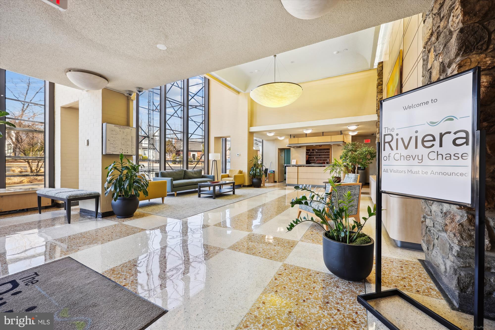 4242 East-West Highway, Unit 414 Chevy Chase, MD 20815 - Photo 38 of 66 a lobby with furniture and floor to ceiling window