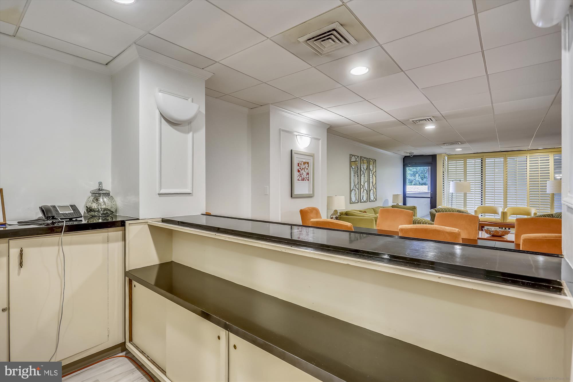 4242 East-West Highway, Unit 414 Chevy Chase, MD 20815 - Photo 46 of 66 a living room with stainless steel appliances granite countertop a sink and a counter space
